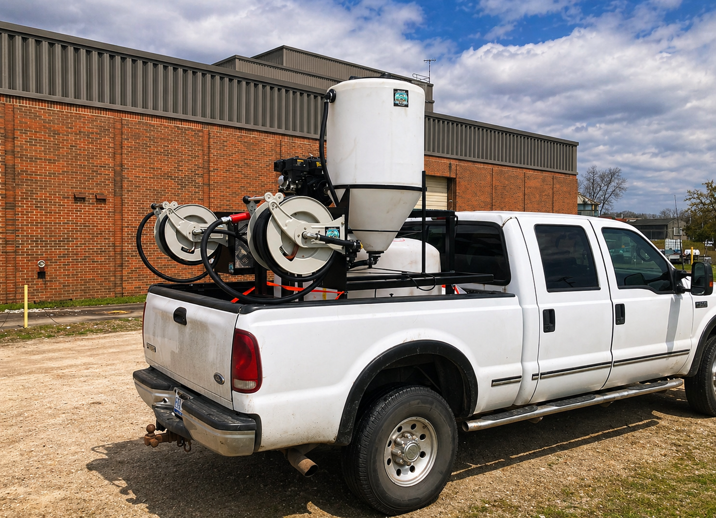 QDS Tiny Tender truck mounted spray system parked in yard beside building