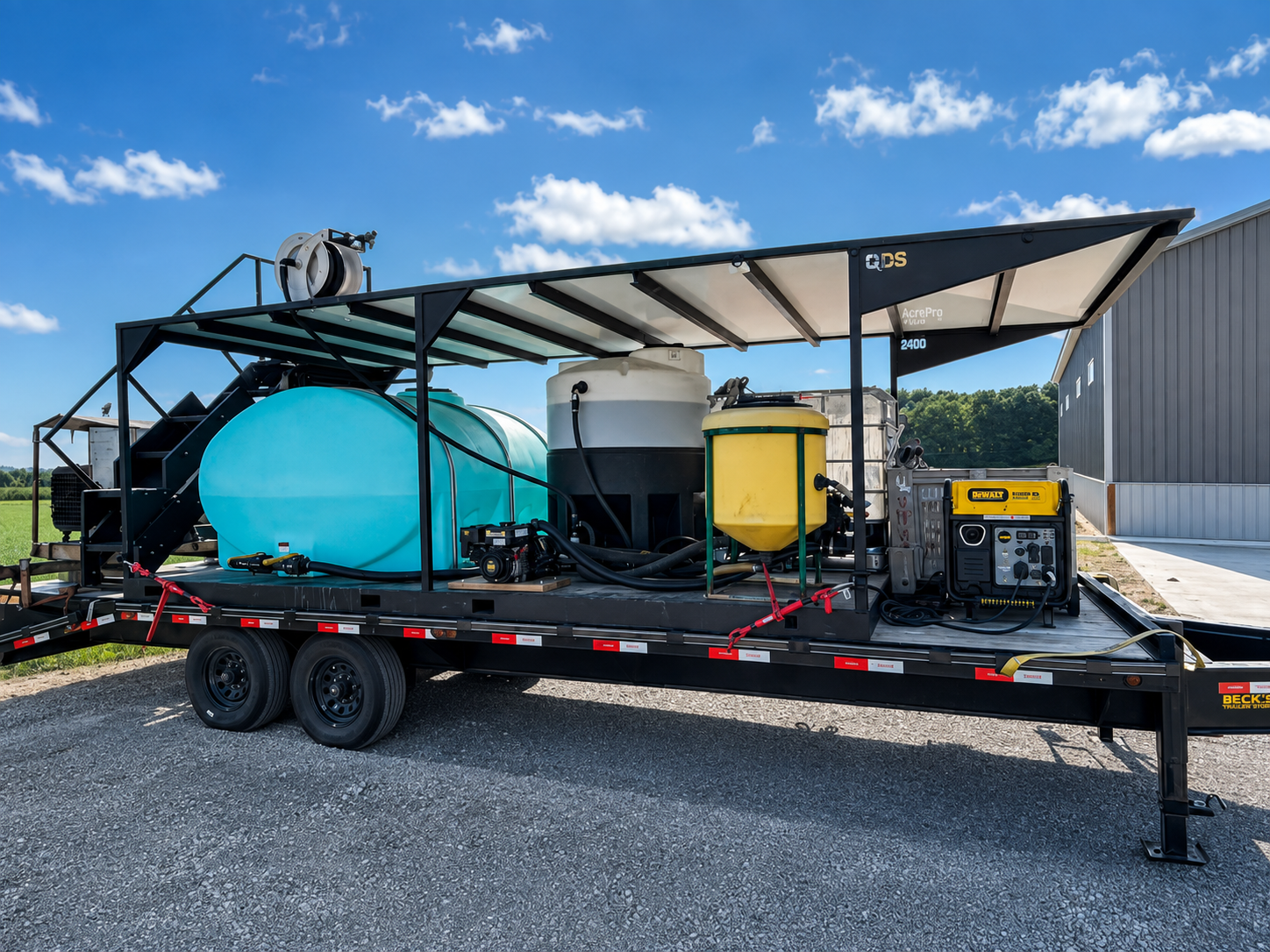 QDS AcrePro agricultural drone trailer skid equipped with water tanks, pumps and a generator